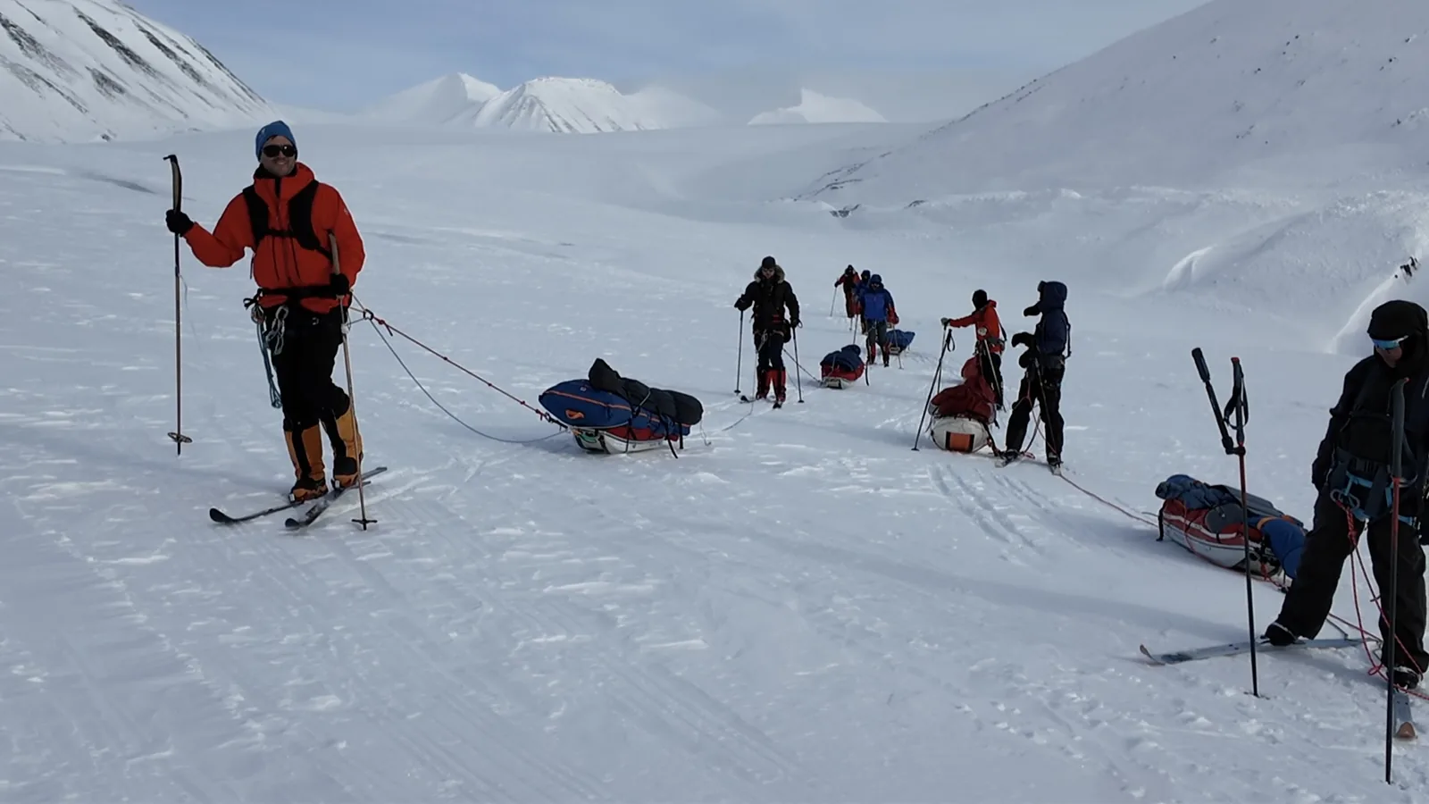 Roped teams with pulks on the glacier
